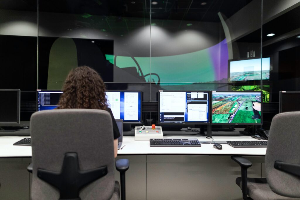 pexels-photo-3862132-3862132 Female engineer managing multiple screens during a technology simulation in a control room.
